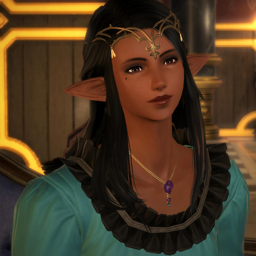 A portrait screenshot of a brown-skinned elezen with brown eyes and black hair, wearing a fancy gold circlet around her head, a golden necklace with a purple flower pendant, and a turquoise green shirt with a black lace trim